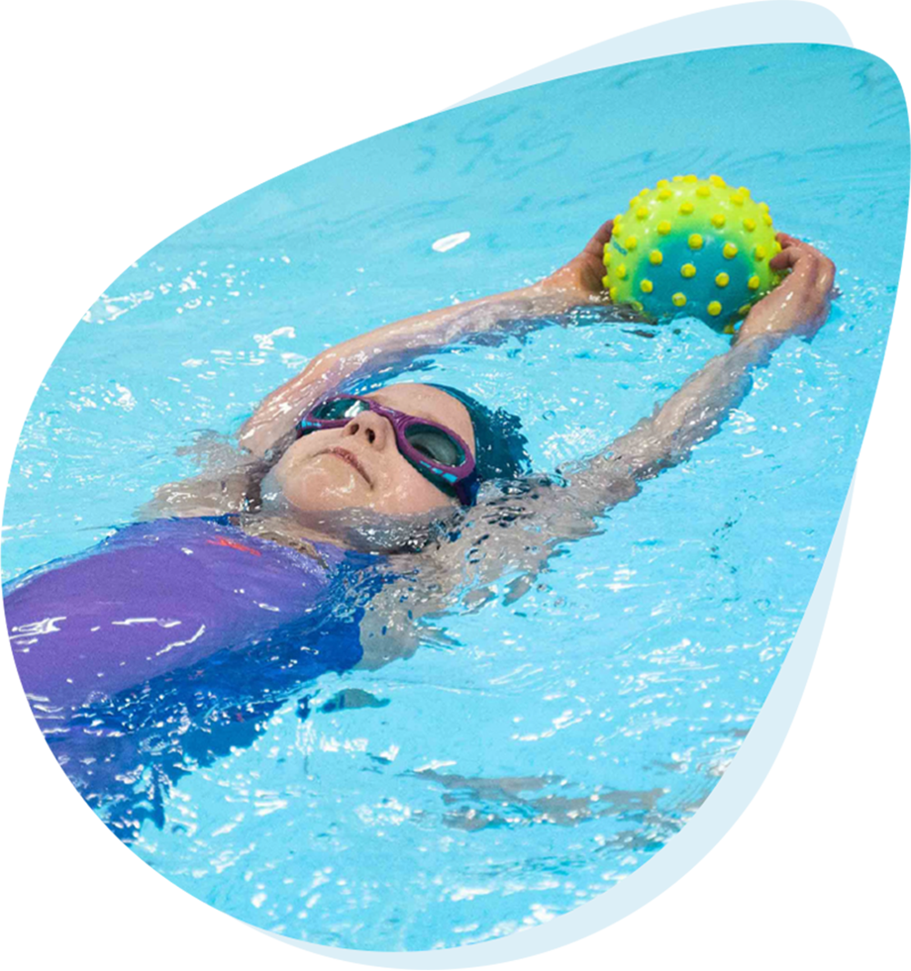 Young child in a swimming lesson with their instructor